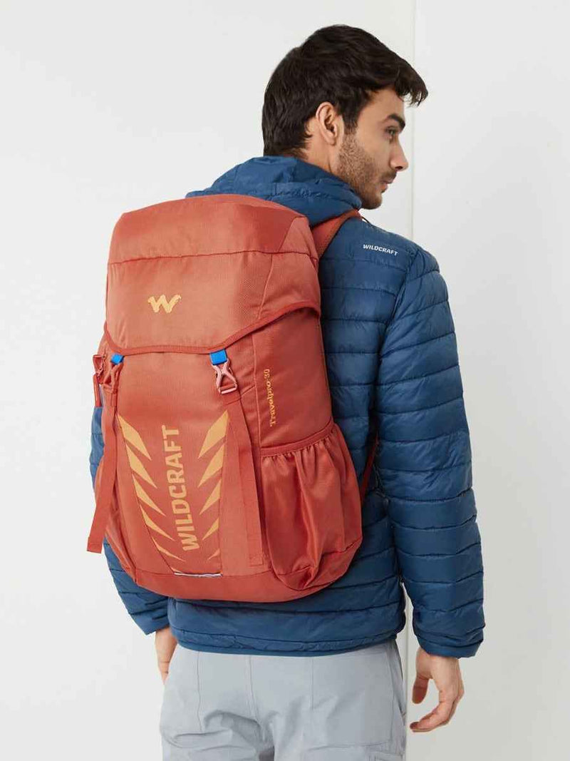 Wildcraft Travel Pro 30 L Rucksack in Pumpkin — worn by a model, rear three-quarter view