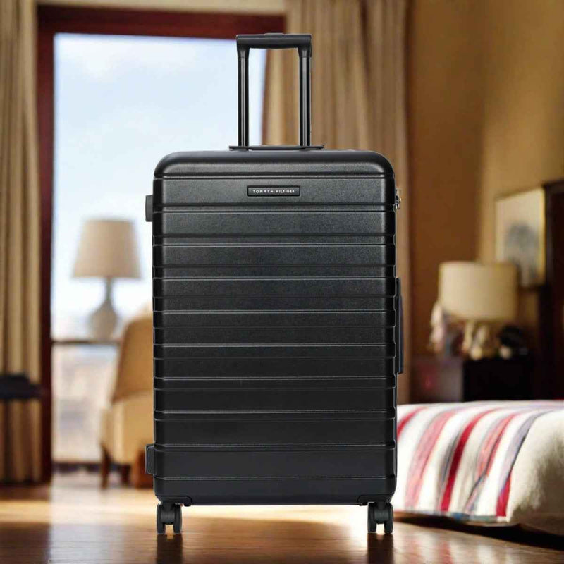 Tommy Hilfiger Hoover X Hardside Trolley Bag in Black — lifestyle shot in a hotel room