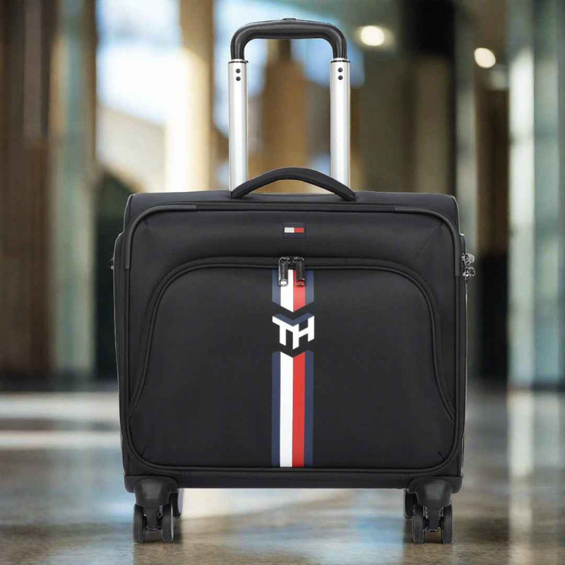 Tommy Hilfiger Kingsville #GoGreen Recycled Overnighter Bag in Black — front view, hotel lobby setting
