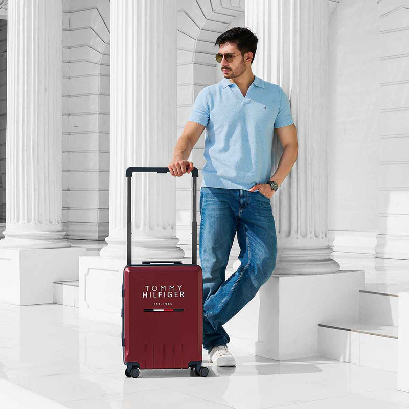 Tommy Hilfiger Broadway Hardside Trolley Bag in Wine — lifestyle shot with model