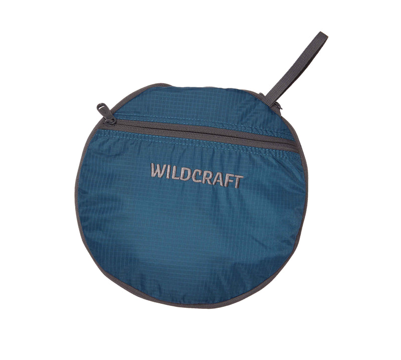 Wildcraft Frisbee Compressible Duffle Bag in Teal — folded into its round zip pouch