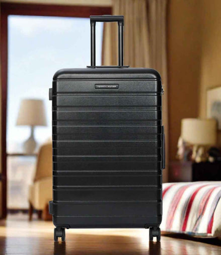 Tommy Hilfiger Hoover X Hardside Trolley Bag in Black — lifestyle shot in a hotel room