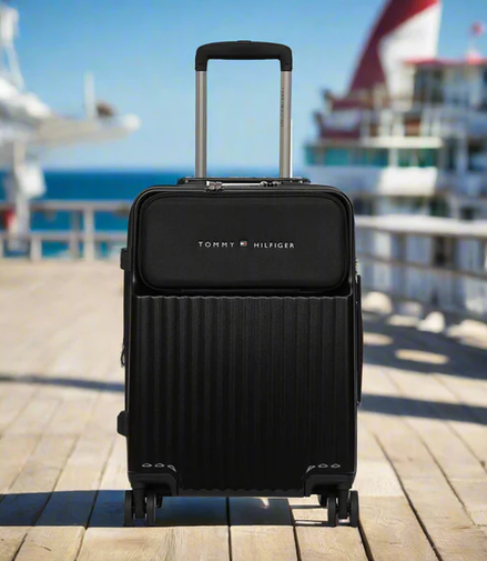 Tommy Hilfiger Pittsburg Hardside Trolley Bag in Black — lifestyle shot on a harbour boardwalk