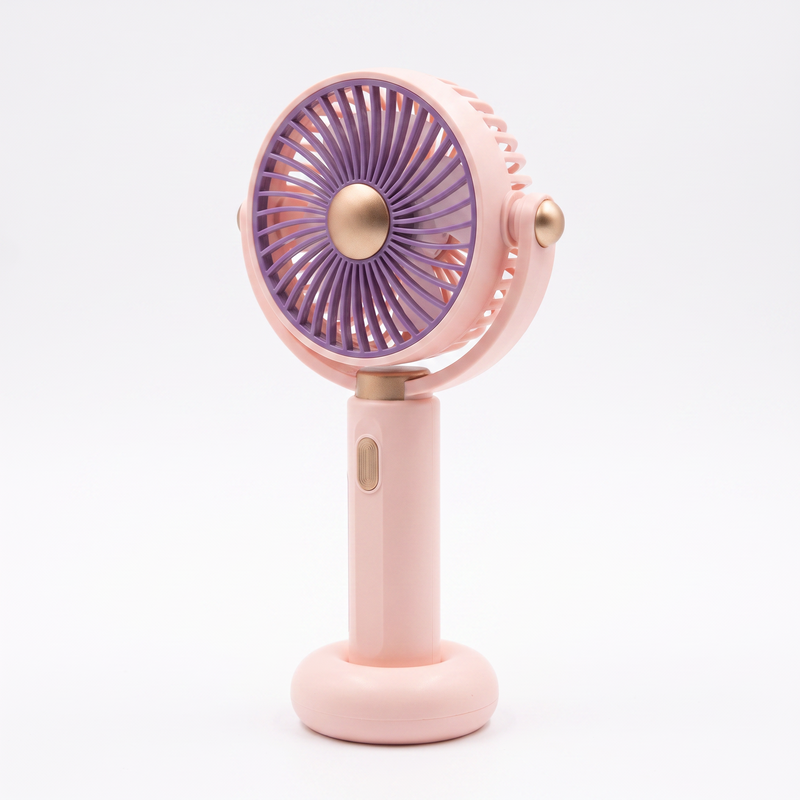 LS pink handheld mini fan at a three-quarter angle, showing the folding tilt head, gold pivot bosses and side power button