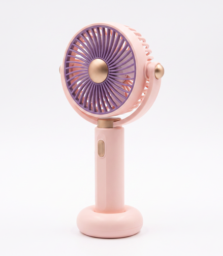 LS pink handheld mini fan at a three-quarter angle, showing the folding tilt head, gold pivot bosses and side power button